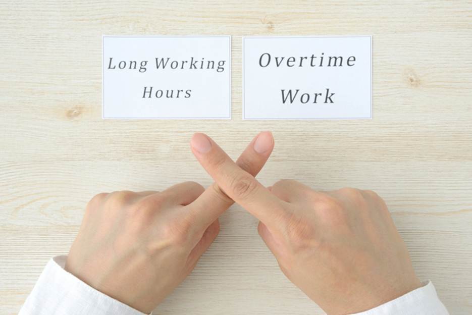 Hands pointing to Overtime Work and Long Working Hours - Overtime Violations